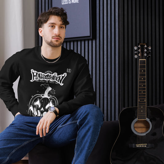 Man wearing a black Halloween-themed sweatshirt sitting next to an acoustic guitar.